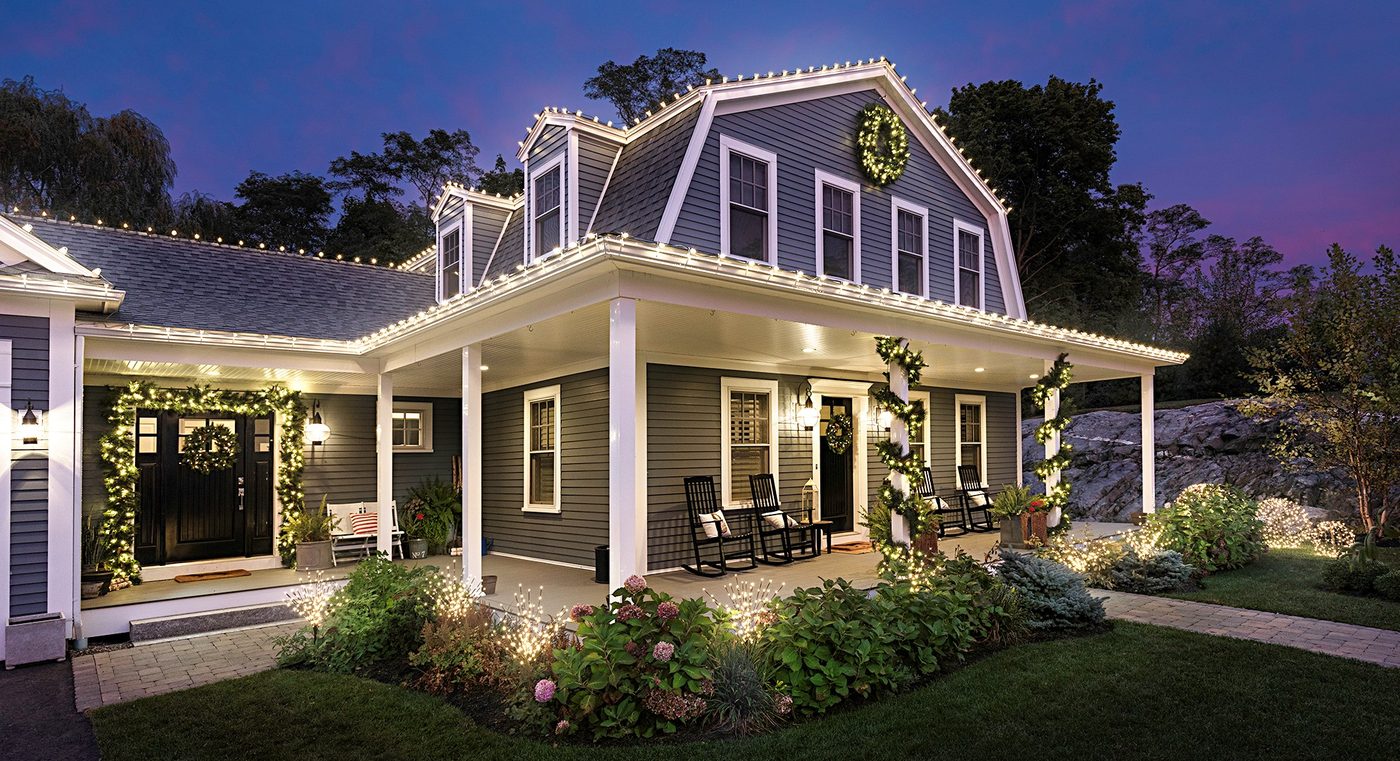 Garland and lit railings on a wraparound porch